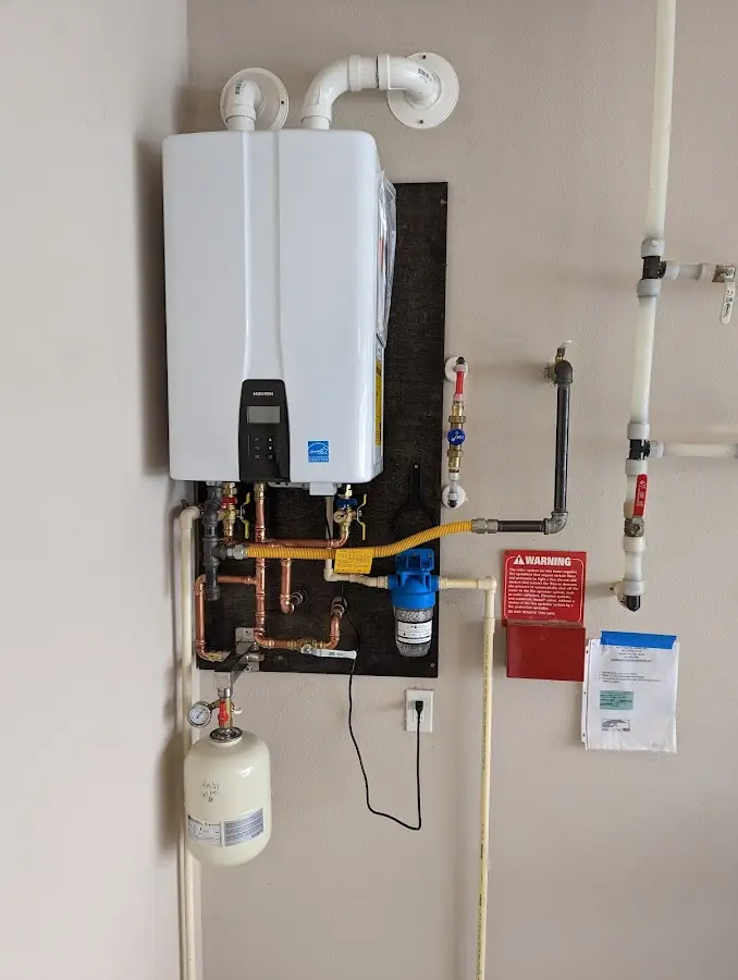 Professional plumber installing copper piping in a Waverly home